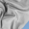 A closeup of the Cotton Blend Sheet Set on a blue background