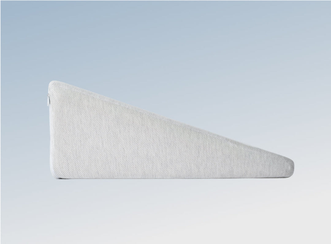 The Helix Wedge Pillow on a blue background